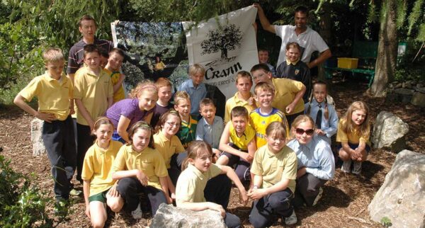 Children taking part in a school woodland project with Crann